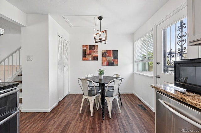 11041 Newland St, Westminster, CO 80020 - dining area featuring dark wood-type flooring, stairs, a chandelier, and baseboards