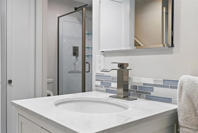 11041 Newland St, Westminster, CO 80020 - full bathroom featuring vanity, backsplash, and a stall shower