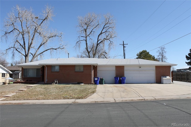 ranch-style house featuring brick siding, concrete driveway, and an attached garage