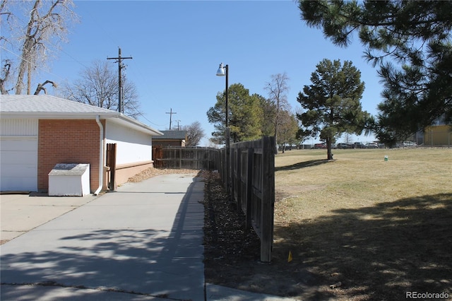 exterior space featuring a garage and fence