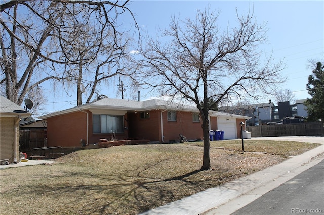 single story home with a garage, brick siding, a front lawn, and fence