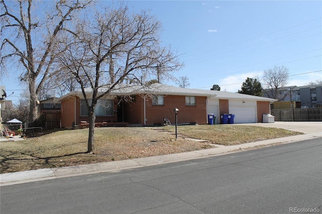 ranch-style house with concrete driveway, fence, and a garage