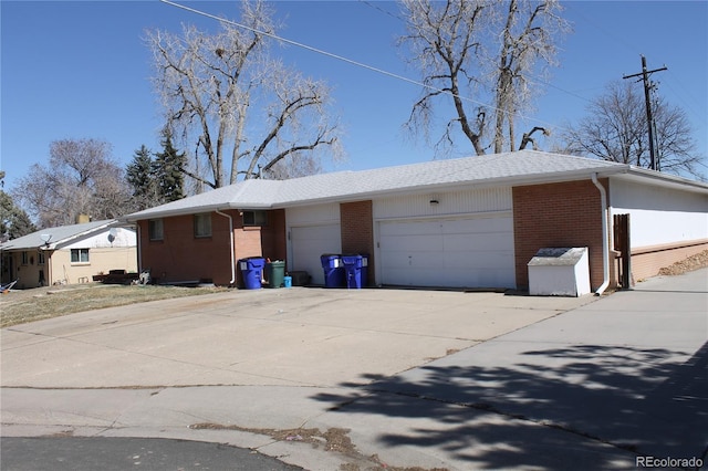 view of front of property featuring brick siding, concrete driveway, and an attached garage