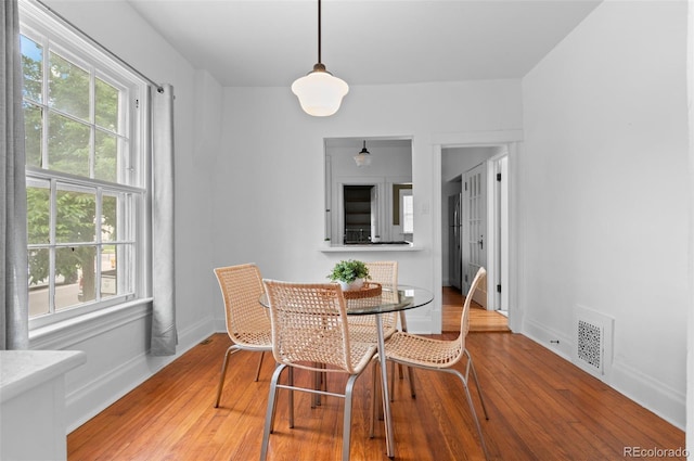 1038 E 4th Ave, Denver, CO 80218 - dining space featuring healthy amount of natural light, wood finished floors, and baseboards