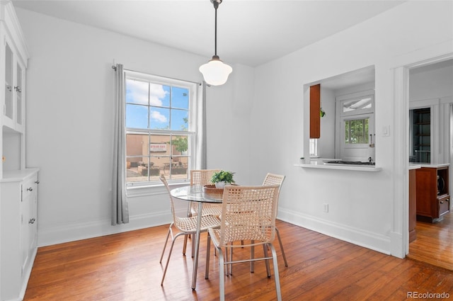 1038 E 4th Ave, Denver, CO 80218 - dining area featuring hardwood / wood-style floors, baseboards, and healthy amount of natural light
