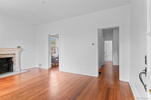 1038 E 4th Ave, Denver, CO 80218 - unfurnished living room with wood-type flooring, a fireplace, and baseboards
