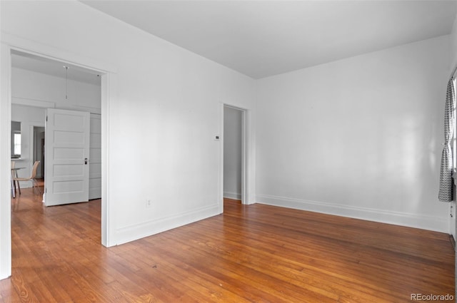1038 E 4th Ave, Denver, CO 80218 - spare room with light wood-style floors, baseboards, and attic access