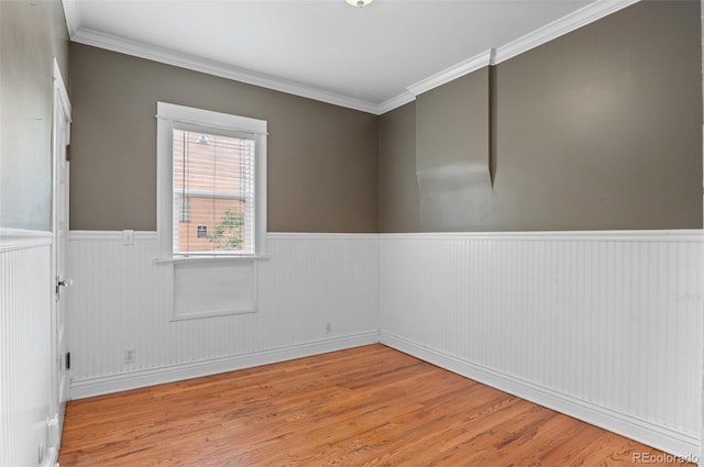 1038 E 4th Ave, Denver, CO 80218 - empty room featuring wainscoting, wood finished floors, crown molding, and baseboards