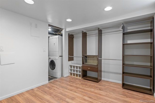 1038 E 4th Ave, Denver, CO 80218 - laundry room with stacked washer and clothes dryer, light wood-type flooring, baseboards, and recessed lighting
