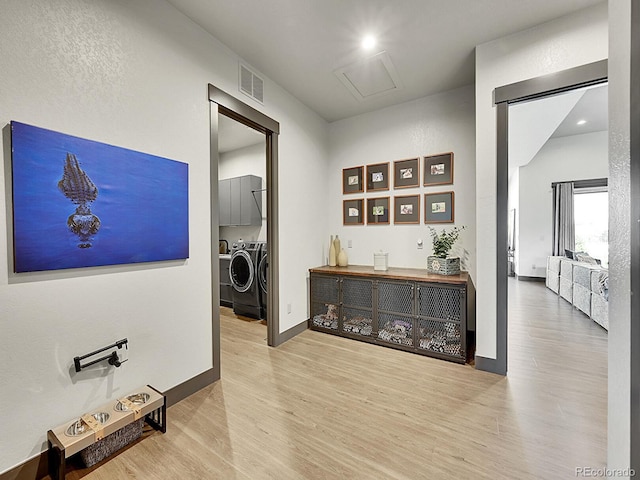 6736 S Flanders Ct, Aurora, CO 80016 - hallway with separate washer and dryer, wood finished floors, and baseboards
