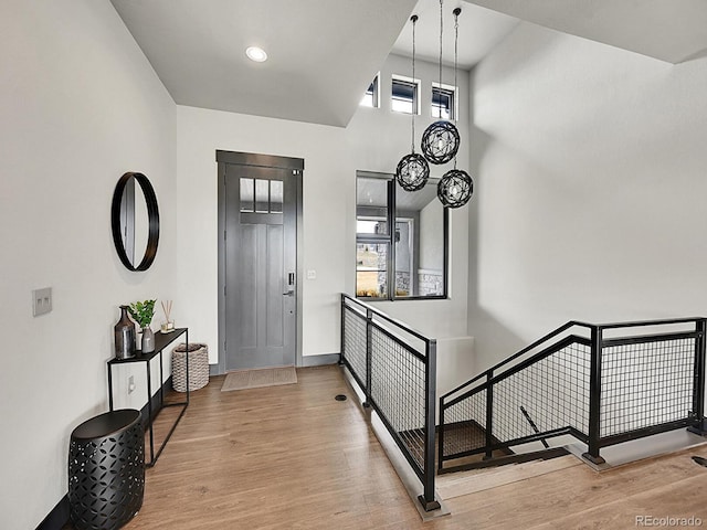 6736 S Flanders Ct, Aurora, CO 80016 - entrance foyer featuring wood finished floors, a high ceiling, and baseboards
