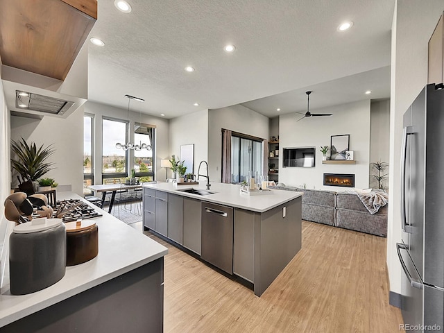 6736 S Flanders Ct, Aurora, CO 80016 - kitchen featuring stainless steel appliances, a sink, light countertops, recessed lighting, and a kitchen island with sink