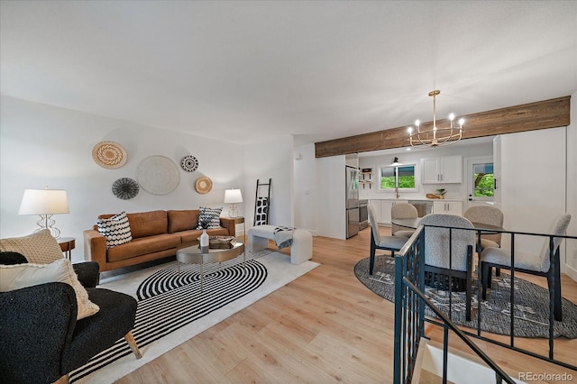 116 Monarch St, Louisville, CO 80027 - living area featuring a chandelier, light wood-type flooring, and beamed ceiling