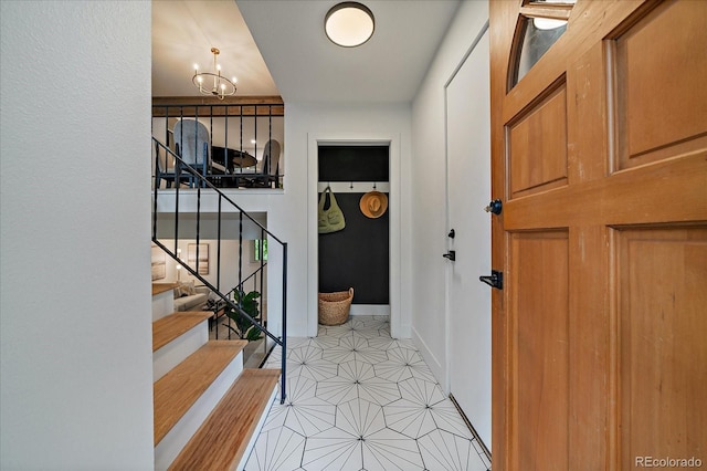 116 Monarch St, Louisville, CO 80027 - entrance foyer with light tile patterned floors, a chandelier, stairs, and baseboards