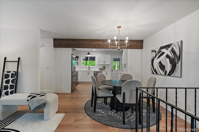 116 Monarch St, Louisville, CO 80027 - dining area with a chandelier, light wood-style flooring, and beamed ceiling