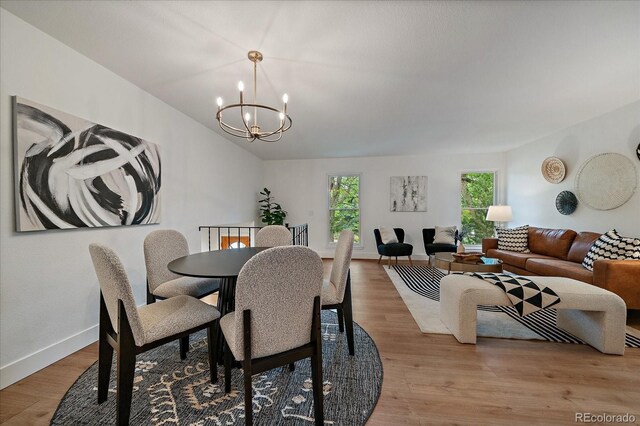116 Monarch St, Louisville, CO 80027 - dining space with a chandelier, light wood-style floors, baseboards, and lofted ceiling