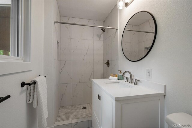 116 Monarch St, Louisville, CO 80027 - bathroom with vanity, tiled shower, toilet, and marble finish floors