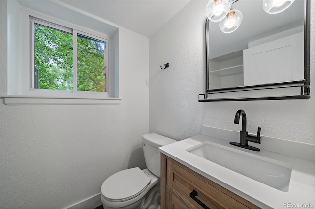 116 Monarch St, Louisville, CO 80027 - bathroom with vanity, toilet, and a textured wall