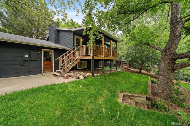 116 Monarch St, Louisville, CO 80027 - rear view of property featuring stairway, a lawn, a chimney, and a wooden deck