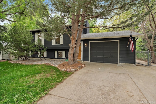 116 Monarch St, Louisville, CO 80027 - split level home featuring driveway, a chimney, and an attached garage