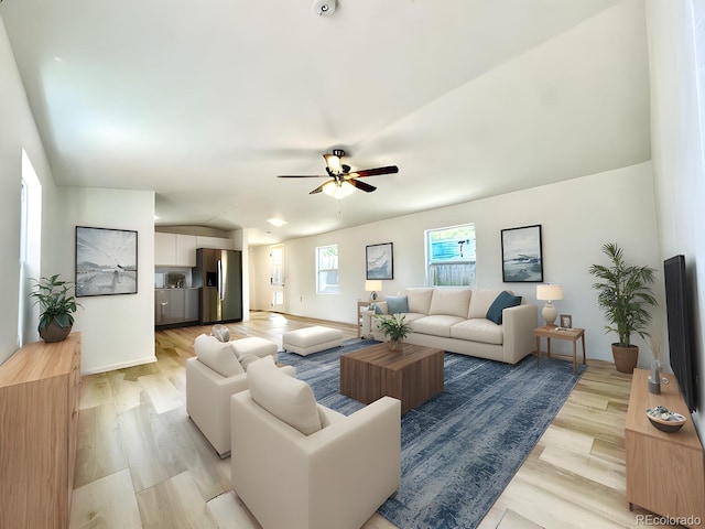 living room with light wood-type flooring, vaulted ceiling, and ceiling fan