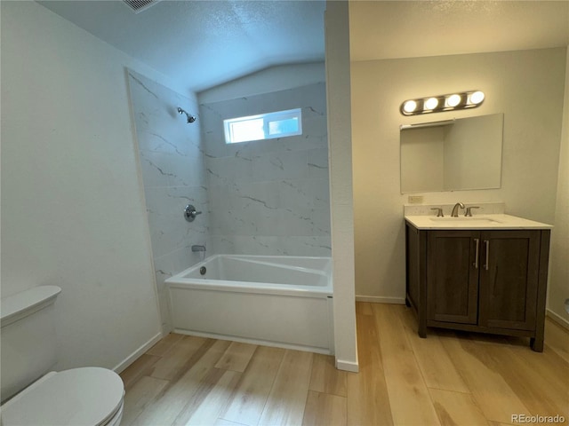 full bathroom with vanity, toilet, tiled shower / bath combo, and hardwood / wood-style flooring