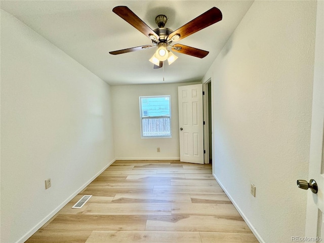 empty room featuring ceiling fan and light hardwood / wood-style floors