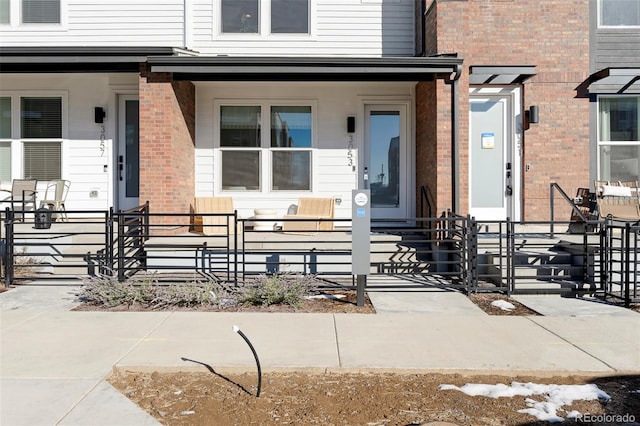 view of exterior entry featuring brick siding