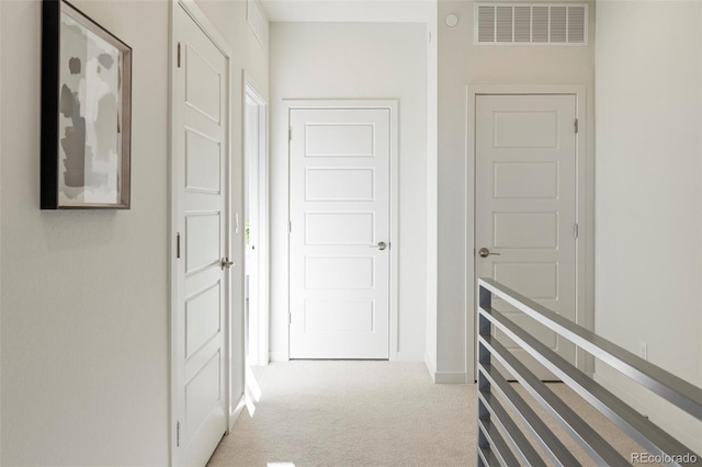 corridor featuring visible vents and light colored carpet