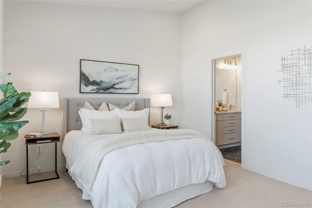 bedroom featuring carpet floors, connected bathroom, and baseboards