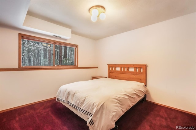 carpeted bedroom featuring baseboards