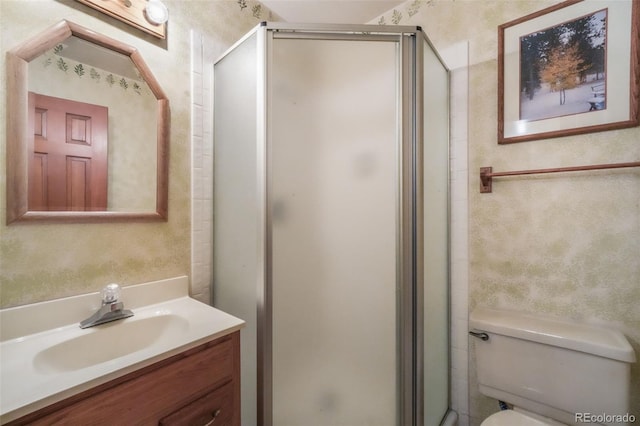 full bathroom featuring a stall shower, toilet, and vanity