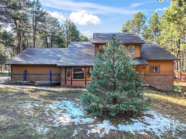 view of front of home featuring brick siding
