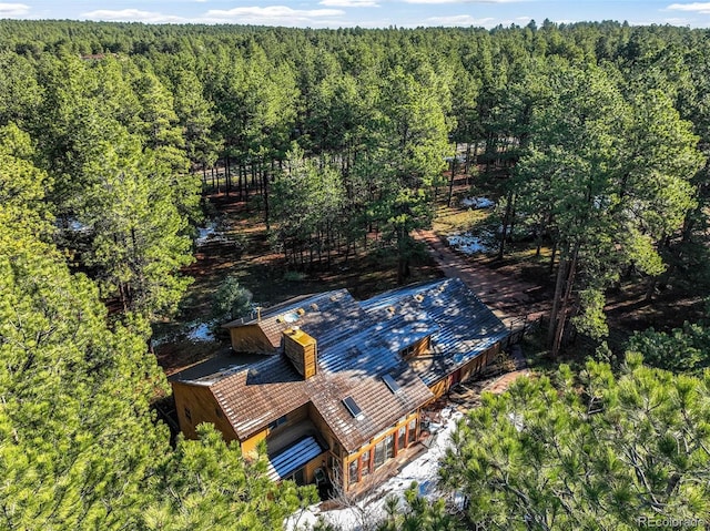 aerial view of property and surrounding area featuring a forest