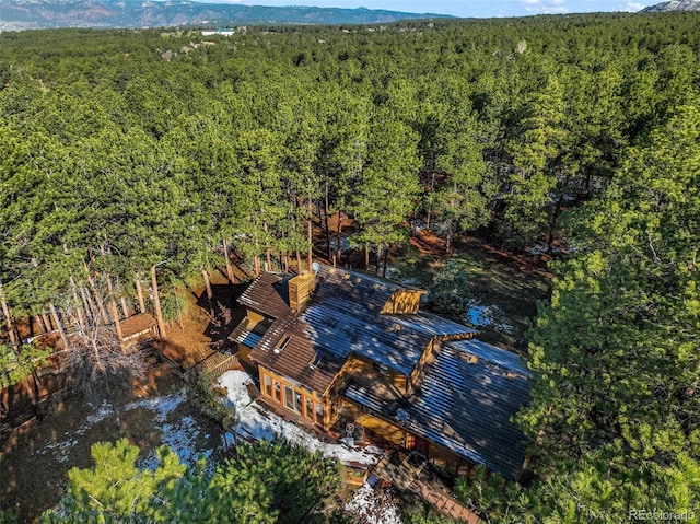 aerial view of property and surrounding area with a forest