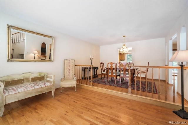 dining room featuring wood finished floors and a chandelier