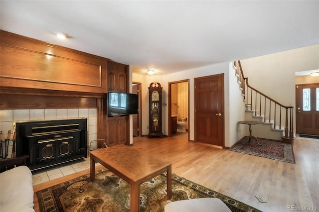 living room featuring light wood-type flooring and stairway