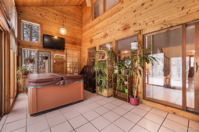 reception area featuring wood walls and high vaulted ceiling