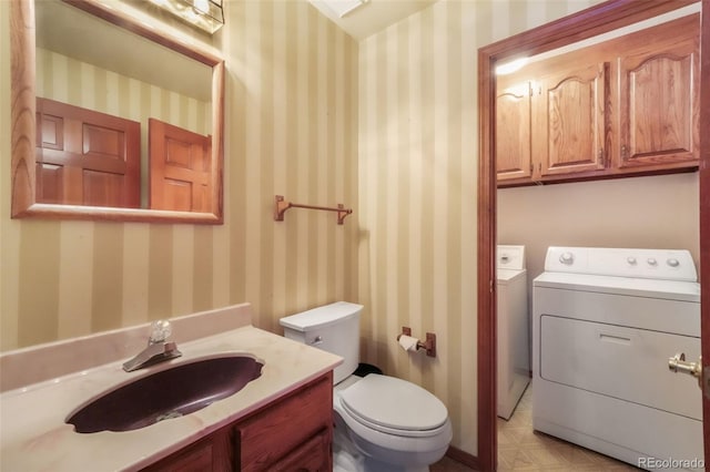 bathroom featuring washer and dryer, toilet, and vanity