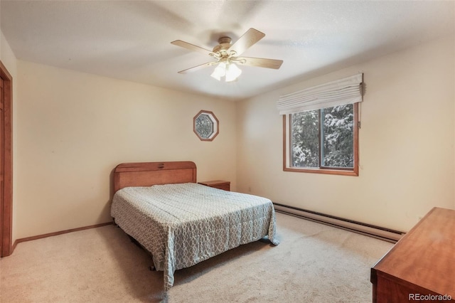 carpeted bedroom featuring baseboard heating, ceiling fan, and baseboards
