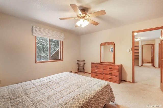 bedroom featuring light carpet, a ceiling fan, and baseboards