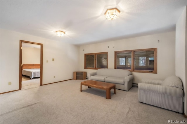 living area featuring carpet and baseboards
