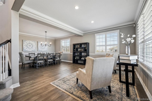 interior space featuring dark wood-style floors, a chandelier, ornamental molding, and baseboards