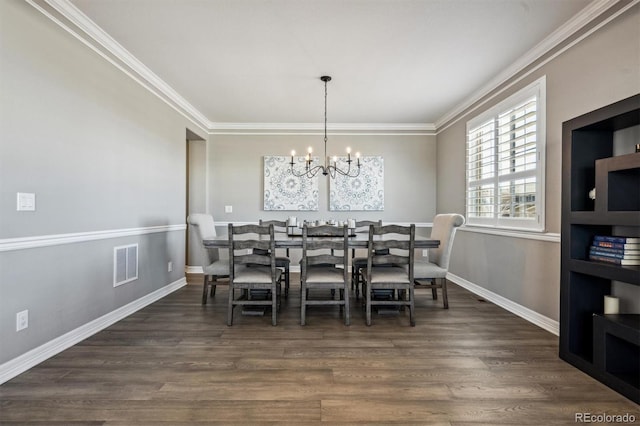 dining space featuring crown molding, dark wood finished floors, visible vents, and an inviting chandelier