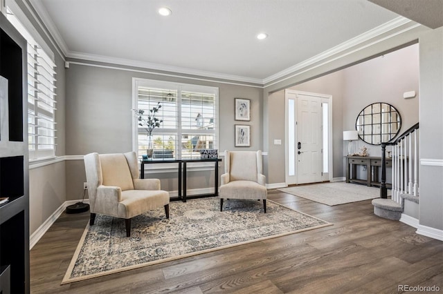 entrance foyer featuring ornamental molding, dark wood finished floors, and stairway