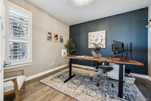 home office with baseboards and wood finished floors