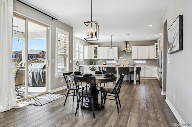 dining space with dark wood-style flooring, recessed lighting, and baseboards