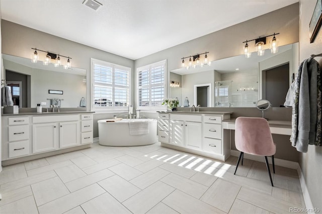 bathroom with visible vents, tile patterned flooring, vanity, a freestanding tub, and a shower stall