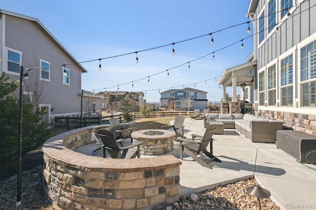 view of patio featuring an outdoor living space with a fire pit