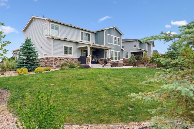 21854 Tyrolite Ave, Parker, CO 80138 - back of property with a patio, board and batten siding, a lawn, and outdoor lounge area